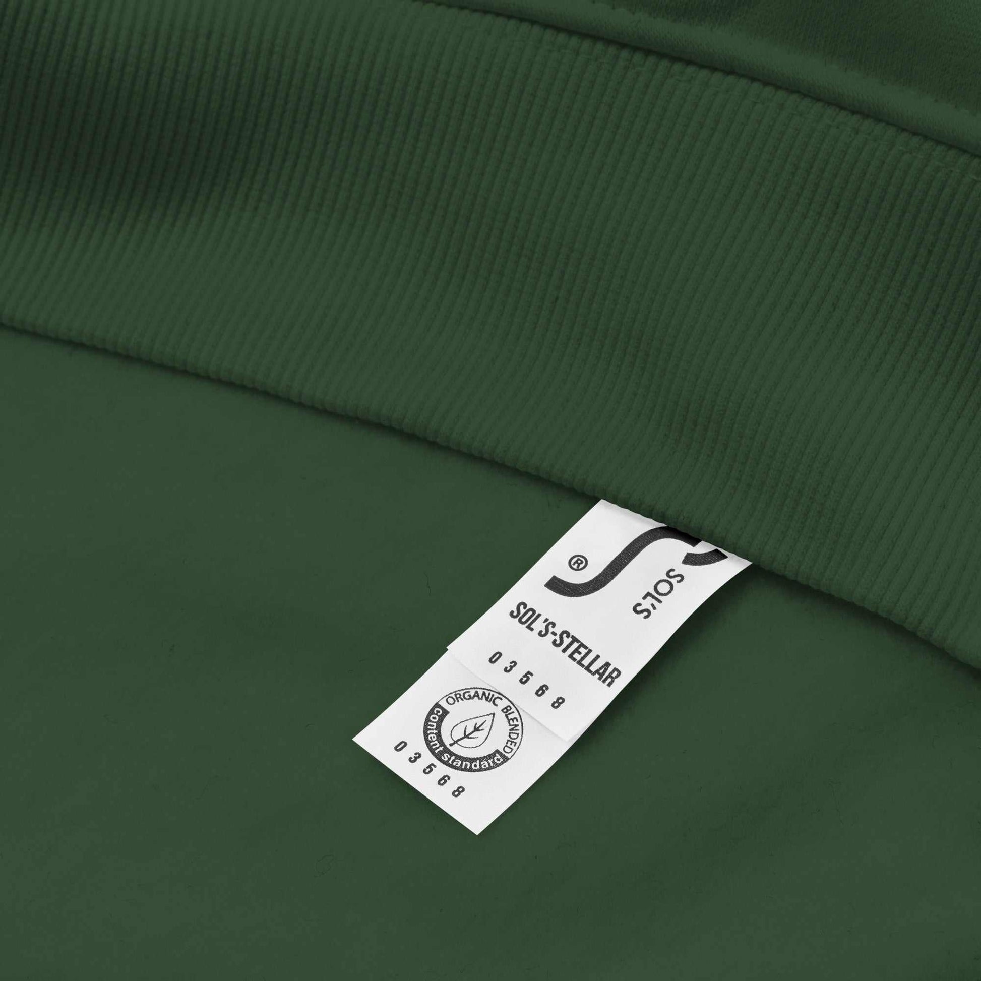 Close-up of green Dashing Through The NO Hoodie showing organic cotton fabric and product label