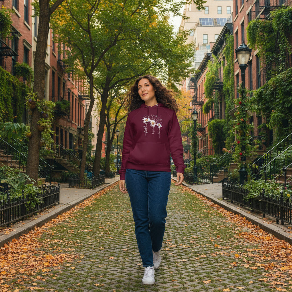 Unisex eco raglan hoodie with floral print in burgundy, organic cotton blend, modeled outdoors in autumn setting