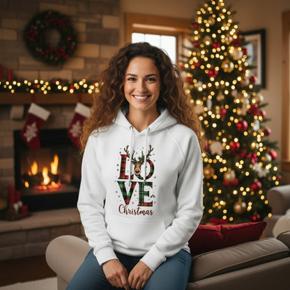 White Love Christmas Unisex Eco Raglan Hoodie with plaid LOVE and reindeer design hanging on festive brick wall background