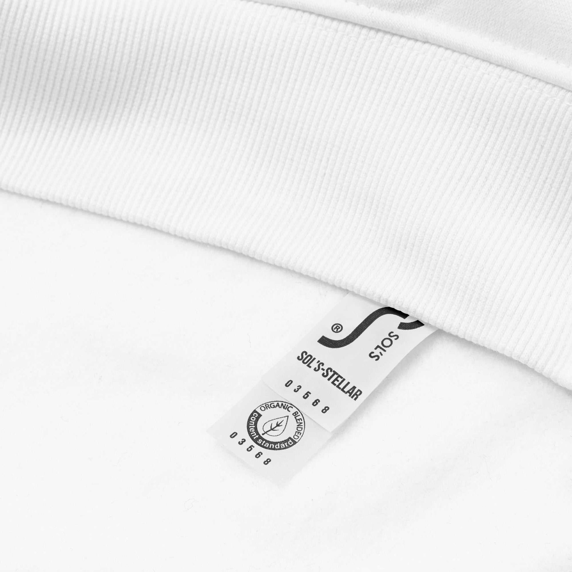 Close-up of the white Dashing Through The NO Hoodie showing the organic cotton fabric tag and ribbed cuff detail