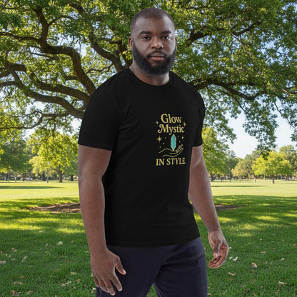 Man wearing black Glow Mystic in Style organic cotton t-shirt with gold logo outdoors in park