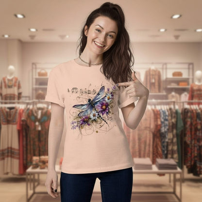Woman wearing Harmony in Flight organic cotton t-shirt with dragonfly and music notes design in soft peach color