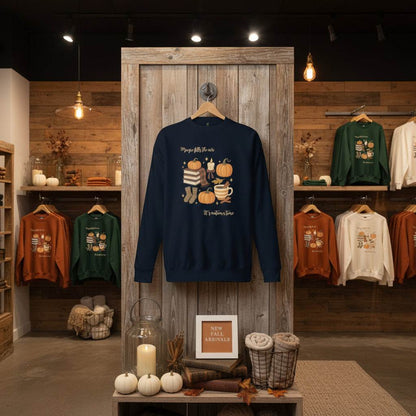 Navy Autumn Magic Classic Sweatshirt with fall-themed pumpkins and cozy design displayed in rustic wooden store setting