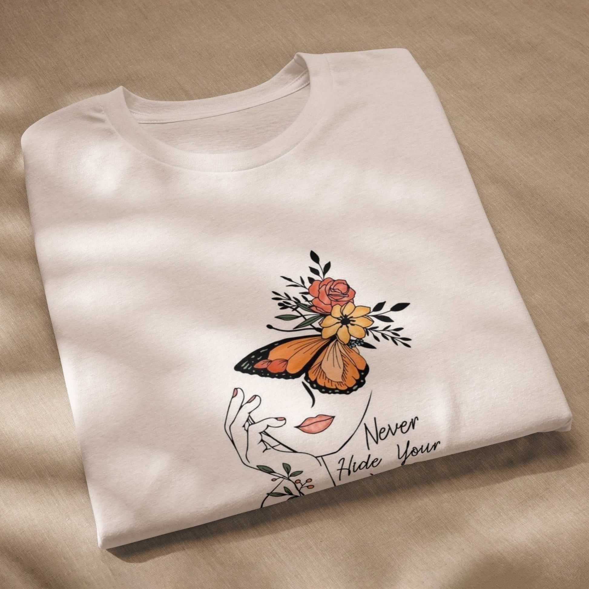 Folded white Butterfly Graphic Organic Cotton T Shirt with orange butterfly and floral design on front