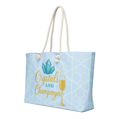 Oversized weekender bag with crystals and champagne design, light blue geometric pattern, and rope handles