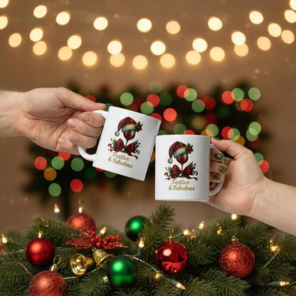 Festive & Fabulous Christmas mug with holiday design held in hands over decorated pine and bokeh lights background