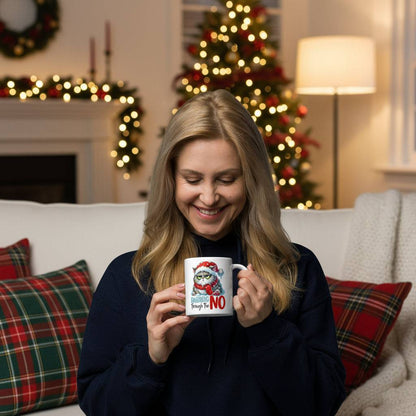 Woman holding funny grumpy Christmas cat mug with festive background