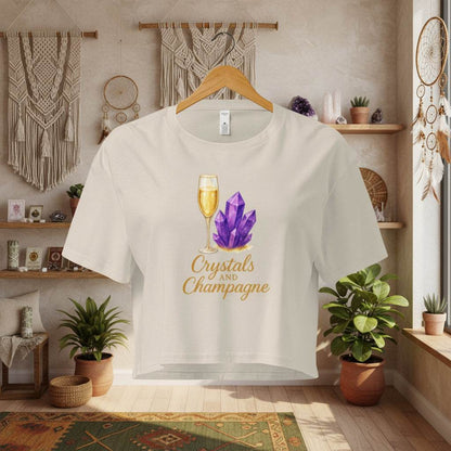 Crystals and Champagne Women's Crop T-Shirt with champagne glass and purple crystals design in cozy boho room setting